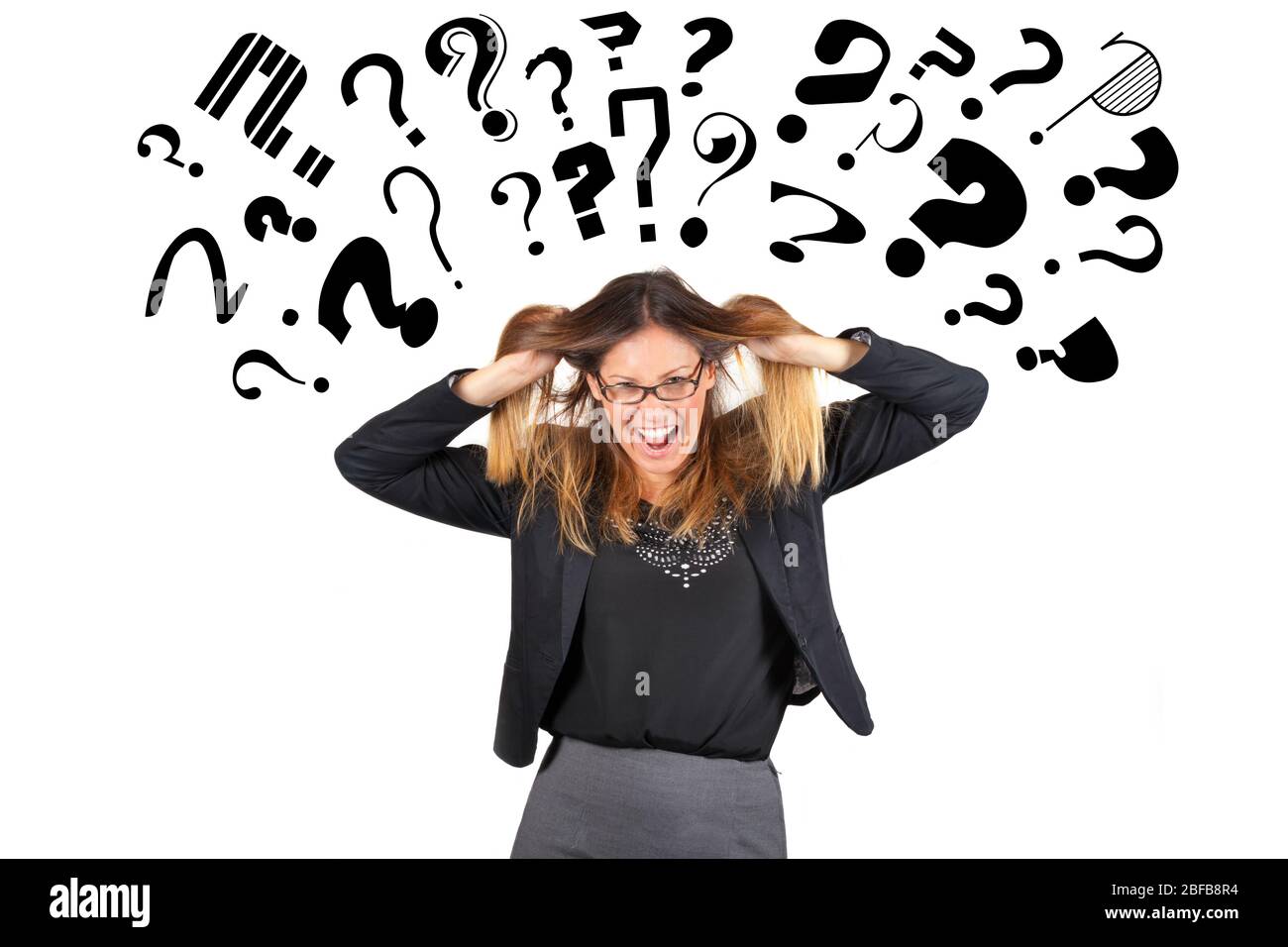 Stressed business woman question marks above head. Pulling hair. A young businesswoman is completely stressed because full of questions and doubts. Stock Photo