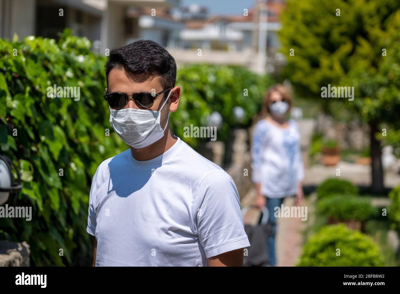 Man wearing a protective mask to protect himself from corona virus. Stock Photo