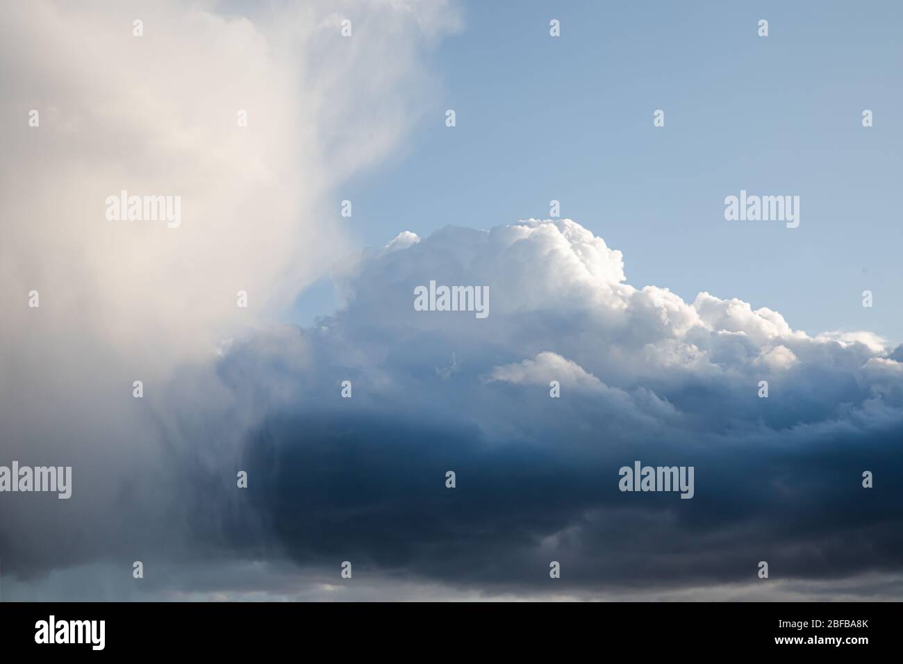 Bright big blue cumulus clouds with silver lining sky background Stock Photo