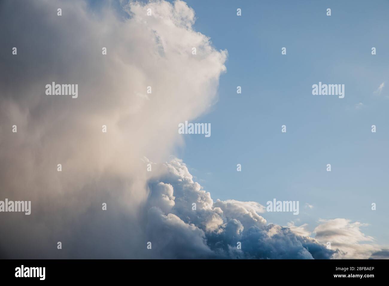 Bright big blue cumulus clouds with silver lining sky background Stock Photo