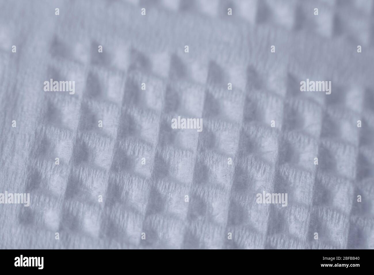 Extremely close-up texture of white paper napkin or towel, natural background, selective focus Stock Photo