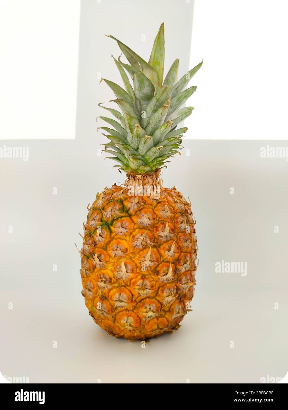 A whole pineapple on white. Vegetarian and healthy food. Nutrition and diet background Stock photo Stock Photo