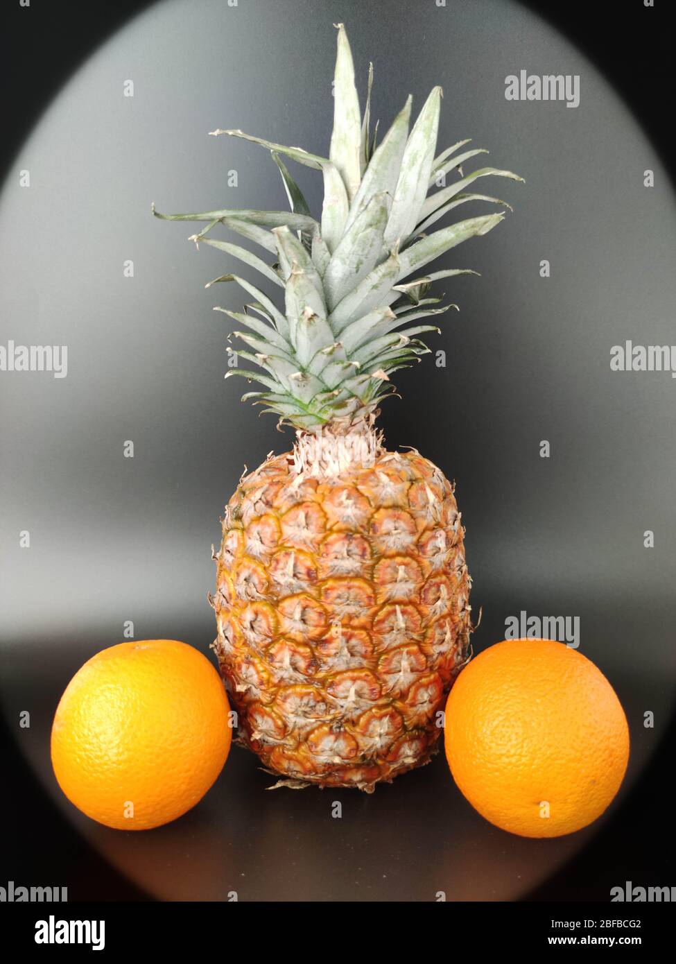 A whole pineapple on black. Vegetarian and healthy food. Nutrition and diet background Stock photo Stock Photo