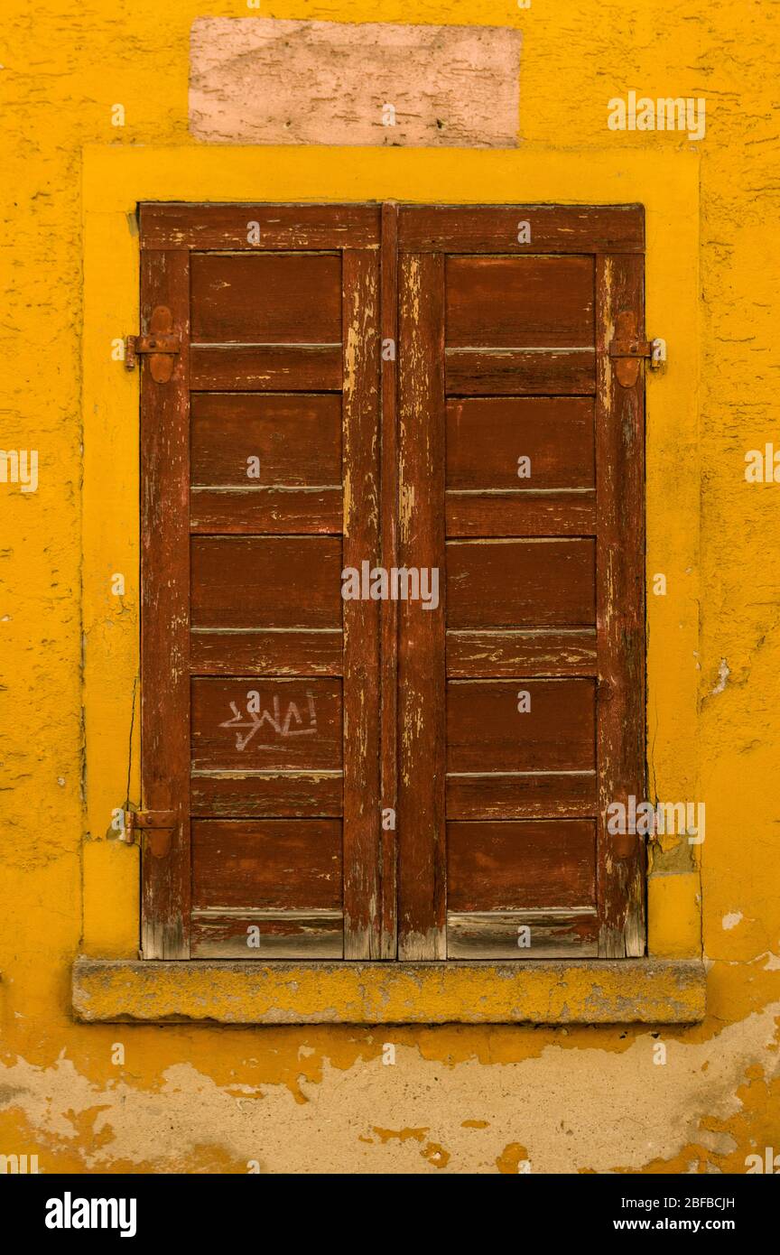Facade with brown wooden shutter of an old house Stock Photo - Alamy