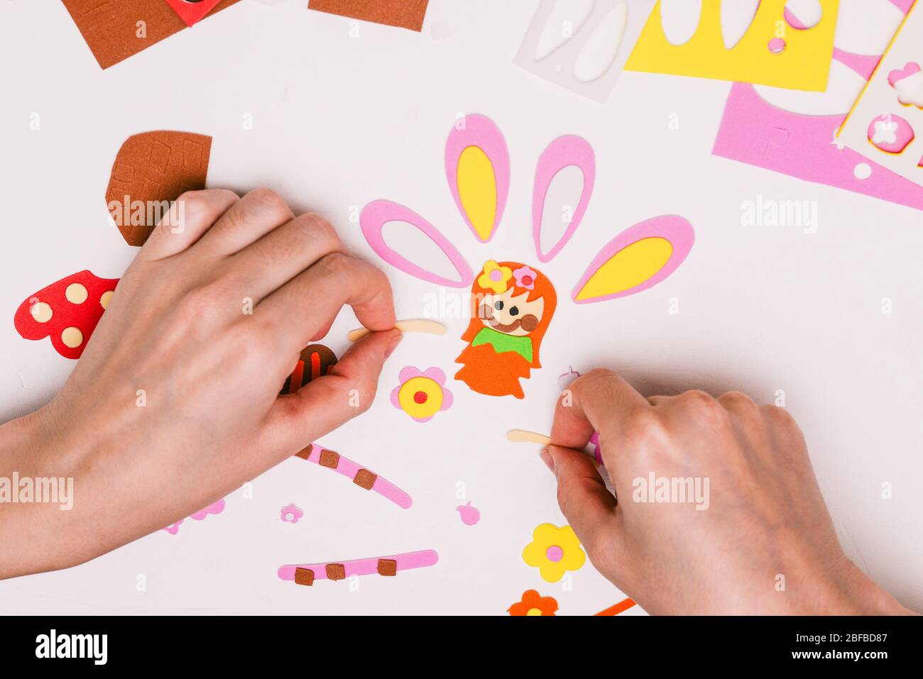 Paper crafts for children. Application of children's creativity.  Kindergarten and craft school. On a beige background, a funny face of a man  made of colored paper. 18906892 Stock Photo at Vecteezy