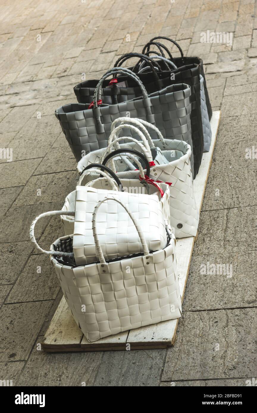 Women's bags shopping baskets for sale standing on boards on the ground
