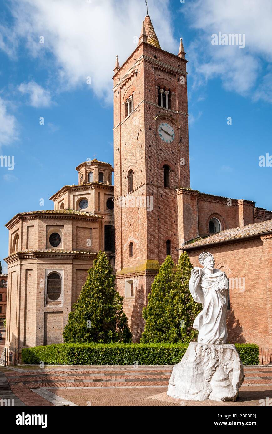 Ancient Church on the Mountain in Tuscany, Abbazia di Monte Oliveto Maggiore with Statue and Road Stock Photo