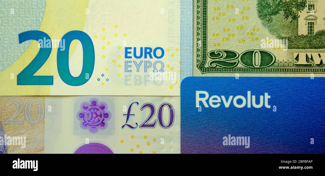 Revolut bank Visa card placed next to 20 pounds, dollars and EURO. The rebranded card with a new updated Revolut logo. Concept. Stock Photo