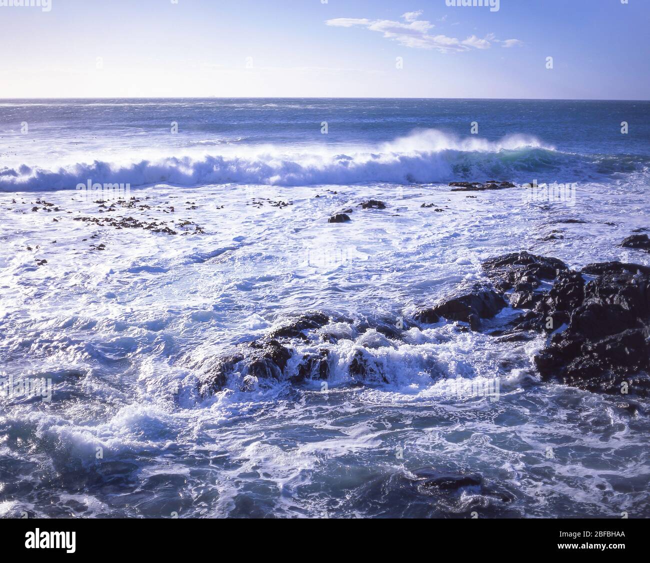Waves breaking over rocks, Kaikoura Coast, Kaikoura, Canterbury Region, South Island, New Zealand Stock Photo