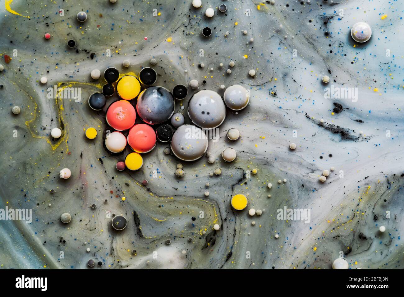 Color drops floating in oil and water over a colorful underground with