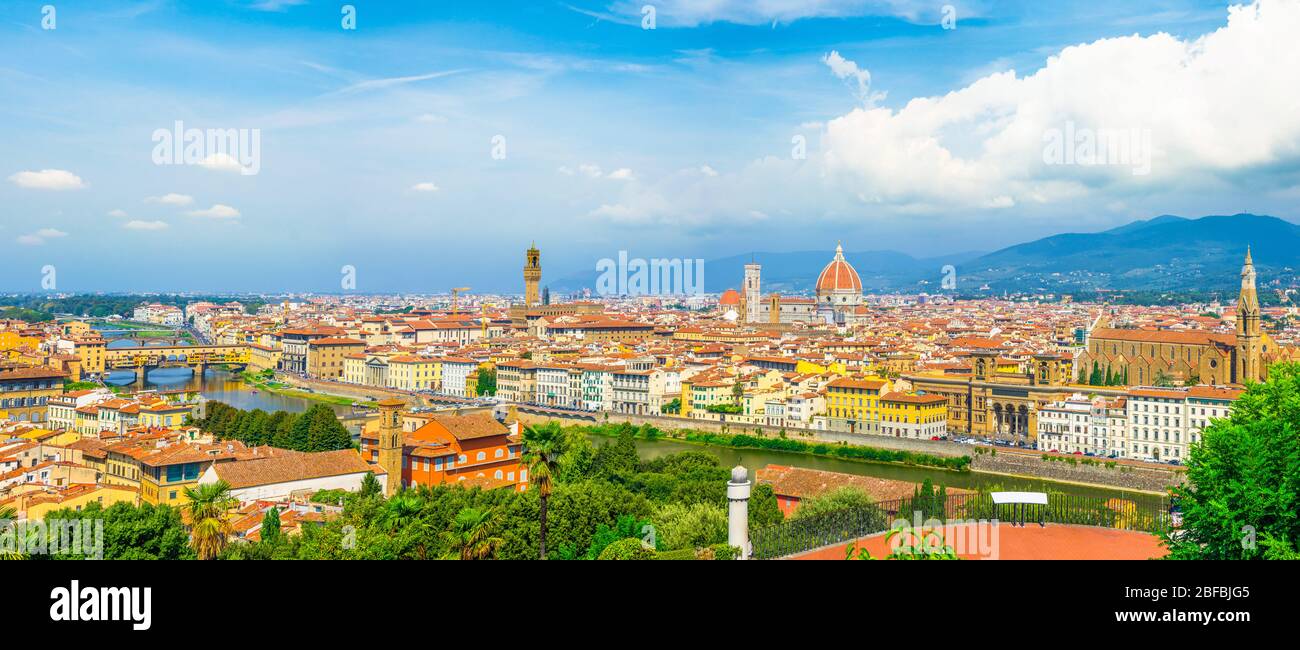 Top aerial panoramic view of Florence city with Duomo Santa Maria del Fiore cathedral, Ponte Vecchio bridge, buildings with orange red tiled roofs, Ar Stock Photo