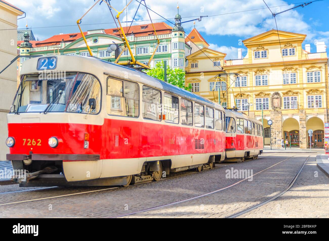 Typical old retro vintage tram on tracks near tram stop in the streets of Prague city near Sternberg palace in Lesser Town (Mala Strana) district, Boh Stock Photo