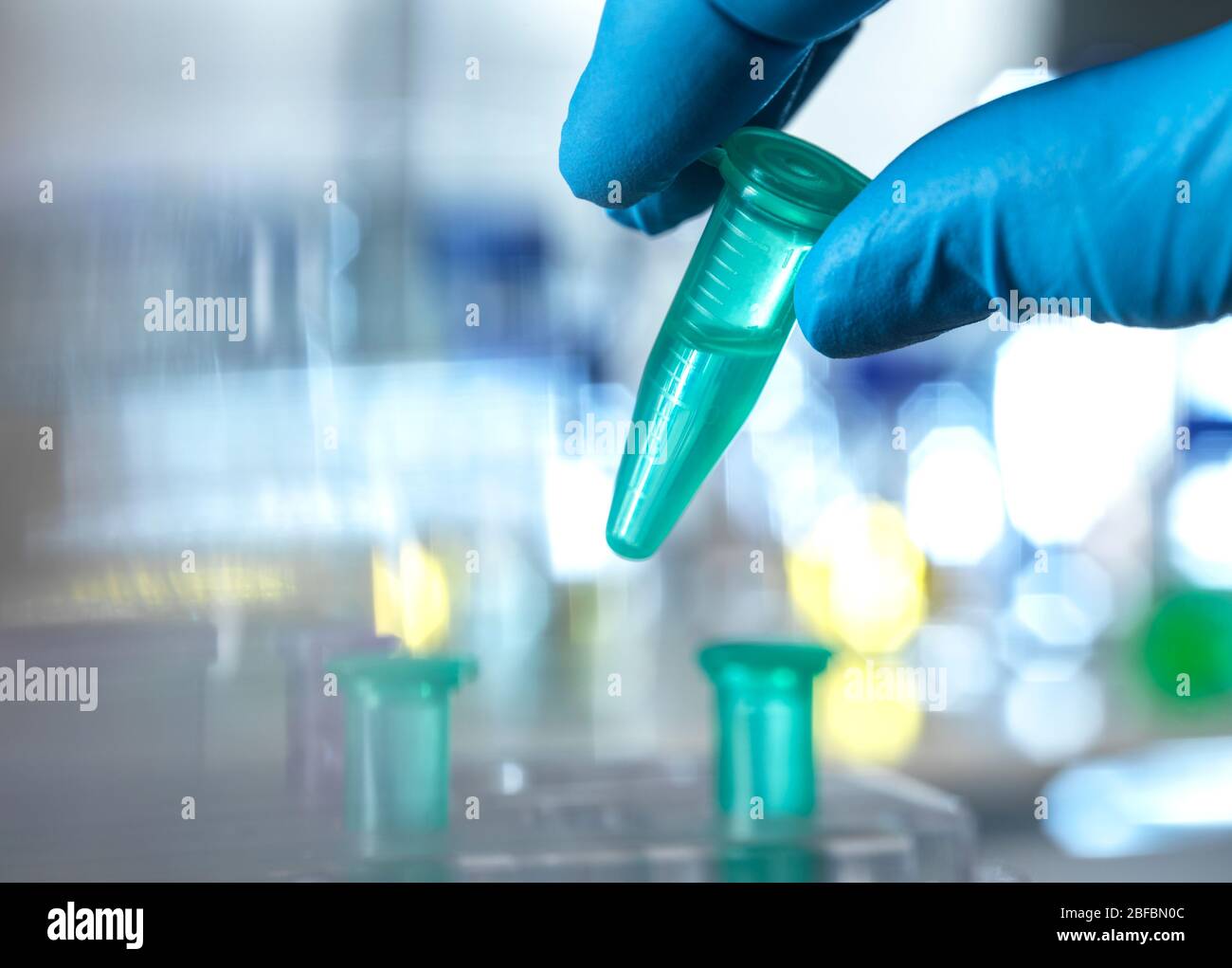 Scientist preparing a sample vial for automated analysis in the lab. Stock Photo