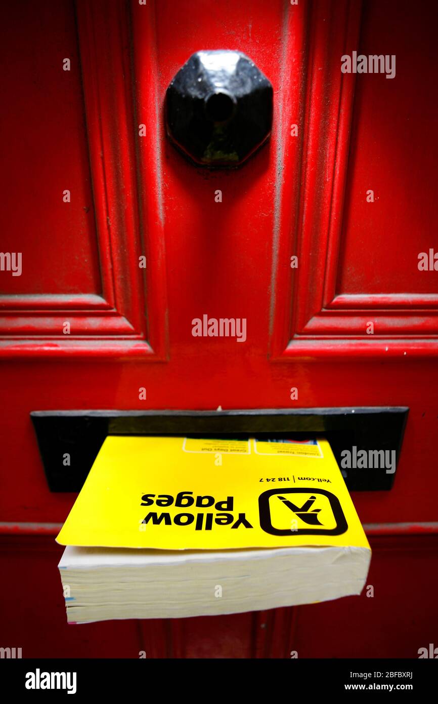 A free phonebook Yellow Pages put through a letterbox Stock Photo Alamy