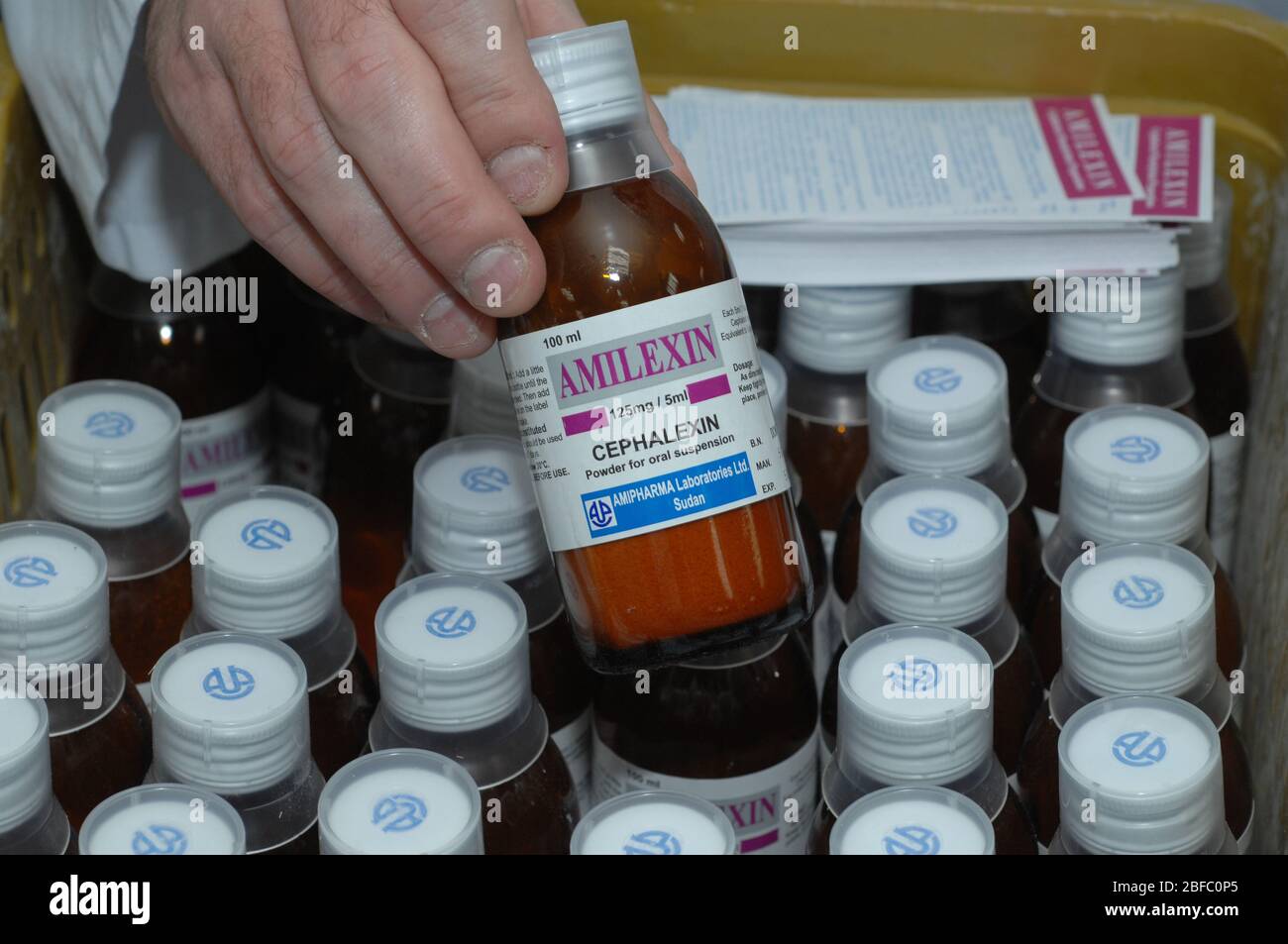 Pharmaceutical worker holding a bottle of cephalexin Cefalexin is used to treat a number of