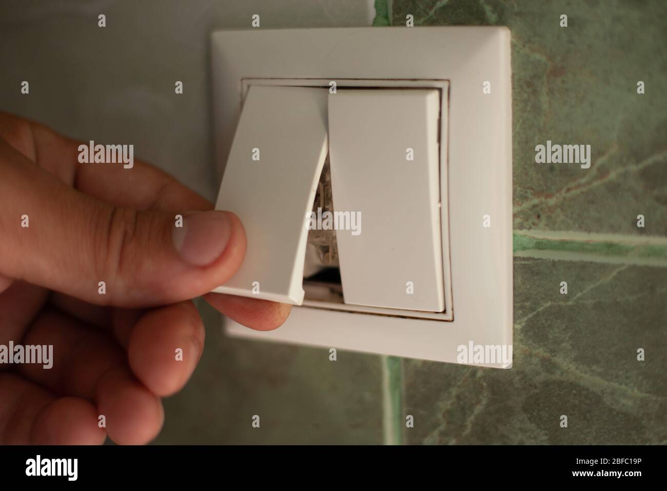 installation of an electric light switch close-up. Stock Photo