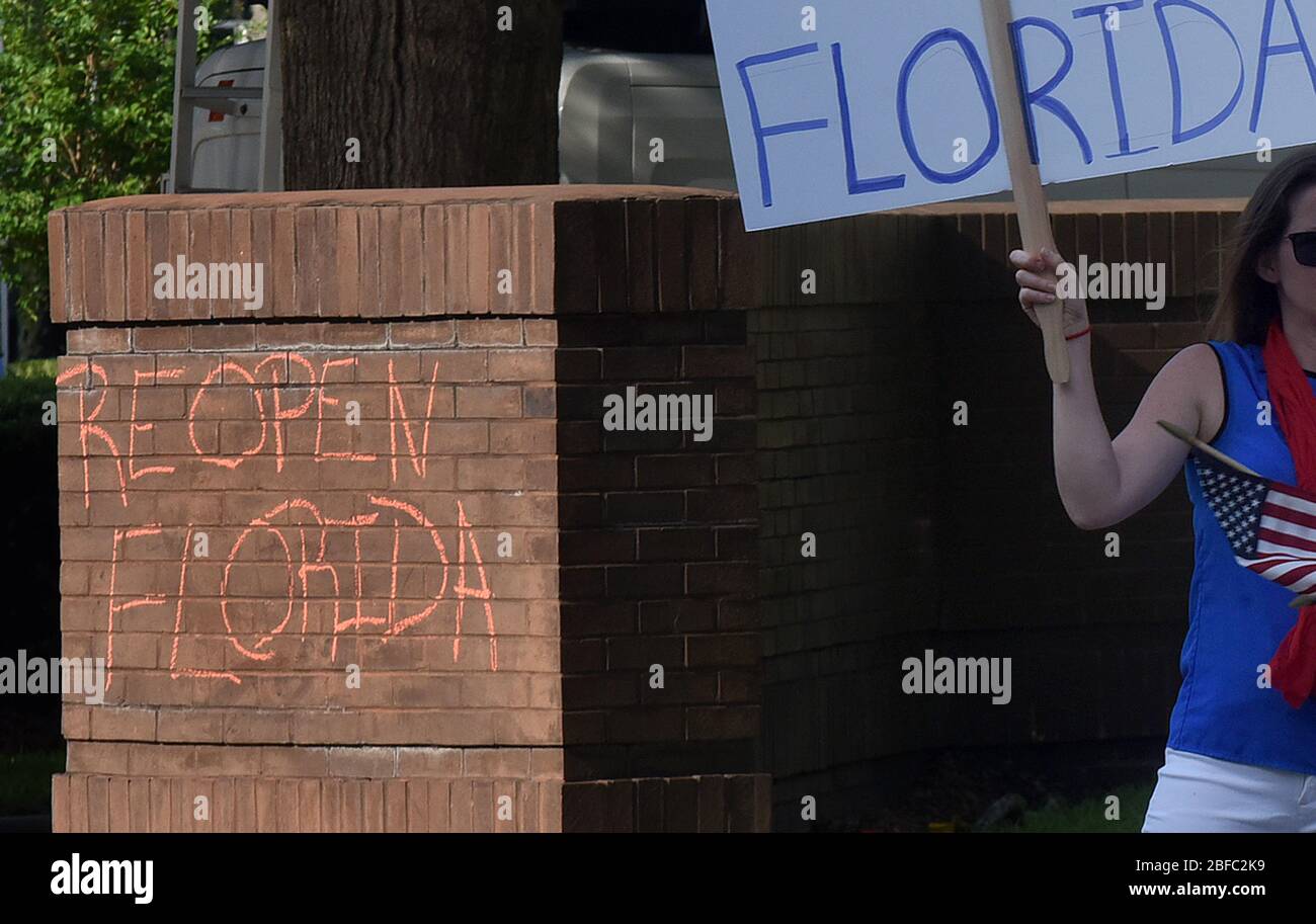 April 17, 2020 - Orlando, Florida, United States - The words 'Reopen Florida' are seen written in chalk as protesters demonstrate outside the Orange County Administration Building in Orlando, Florida on April 17, 2020 demanding the end of stay-at-home orders and the reopening of Florida businesses as the COVID-19 pandemic keeps thousands of people in their homes and out of work. (Paul Hennessy/Alamy) Credit: Paul Hennessy/Alamy Live News Stock Photo