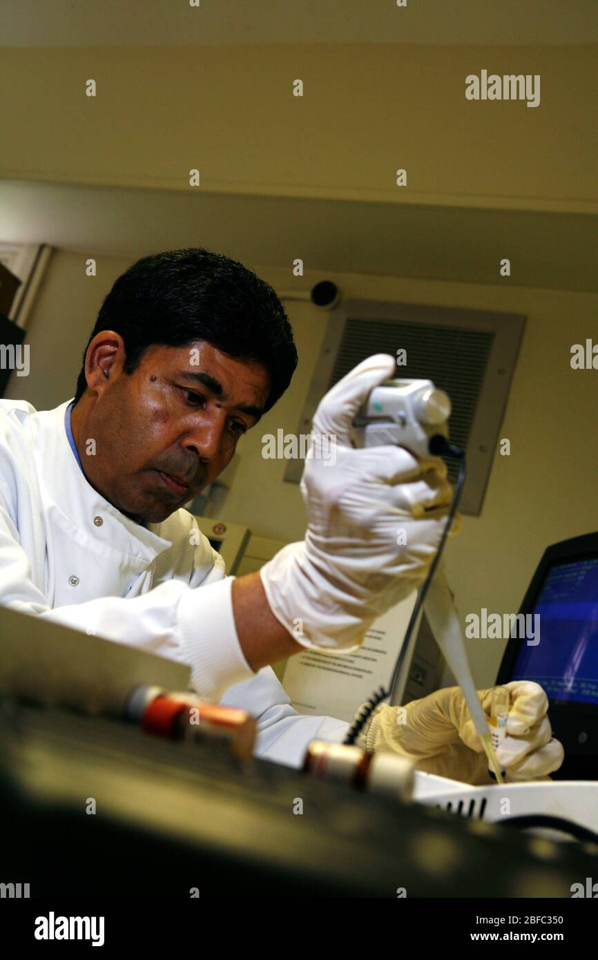 Patologist Tools A pathologist uses an electronic pipette to accurately measure out ...