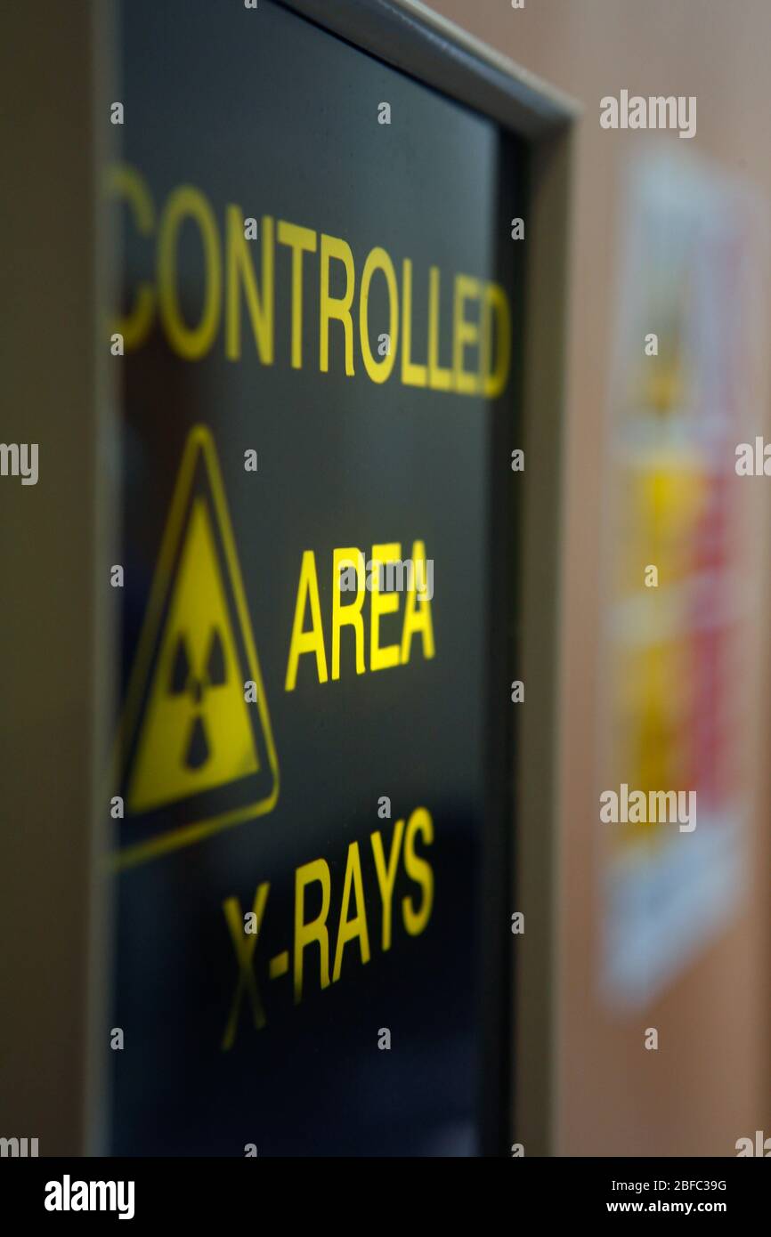 X-ray warning sign. View of an x-ray warning sign, warning the reader that they are about to pass into a controlled area where there is a danger of x- Stock Photo