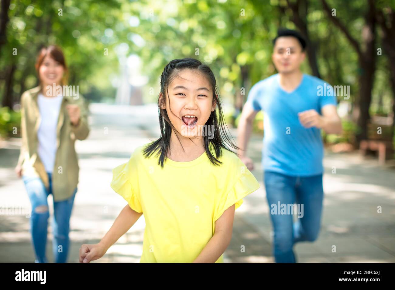 Young asian family with child having fun in nature park Stock Photo