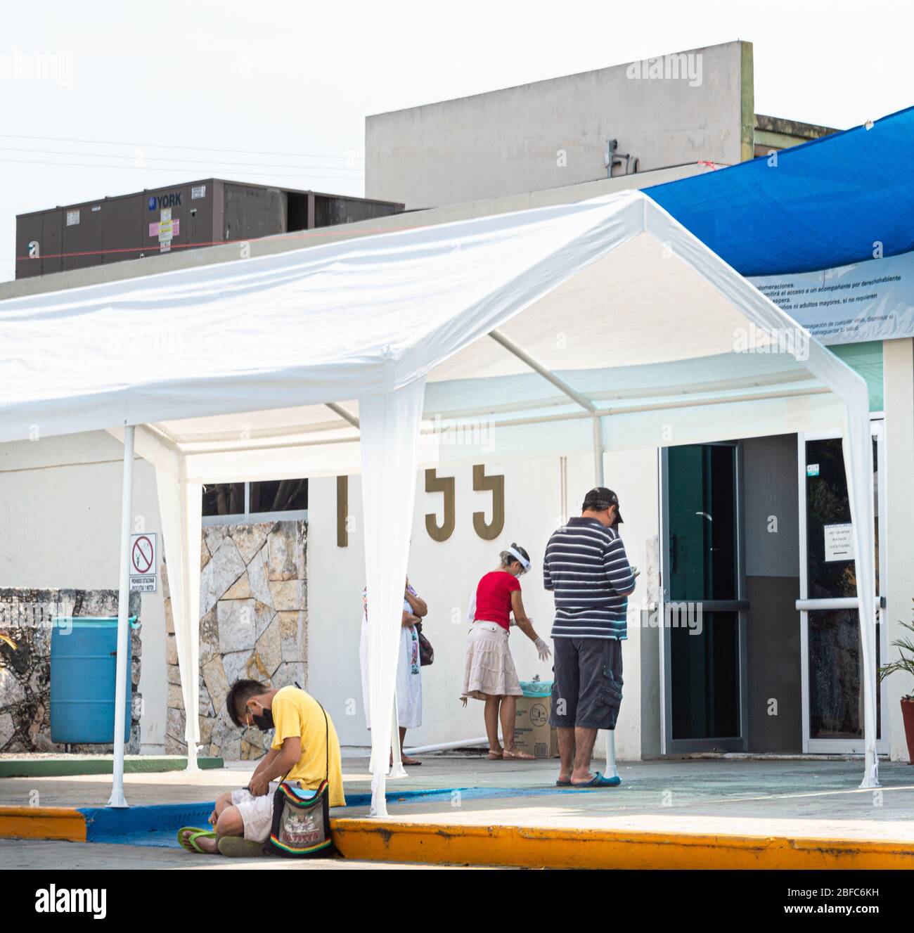 Mexican people waiting to access a hospital in Mexico during the Covid 19 Coronavirus Pandemic. Stock Photo