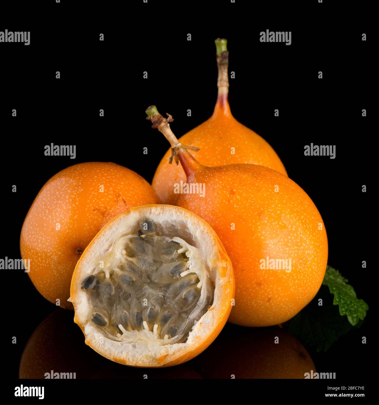 Passion fruit maracuja granadilla on black background Stock Photo - Alamy