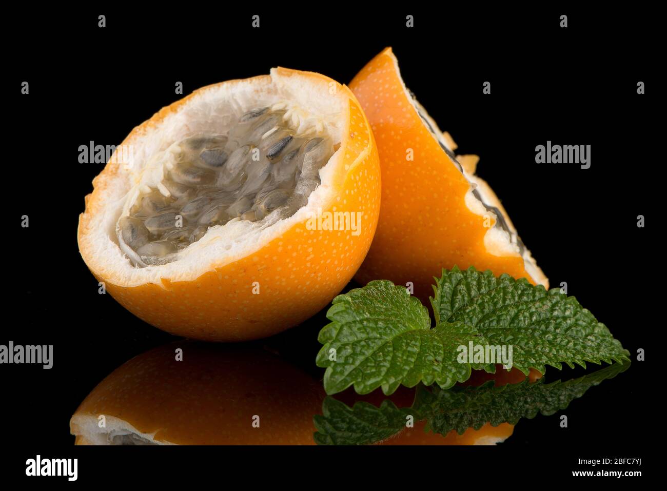 Passion fruit maracuja granadilla on black background Stock Photo - Alamy
