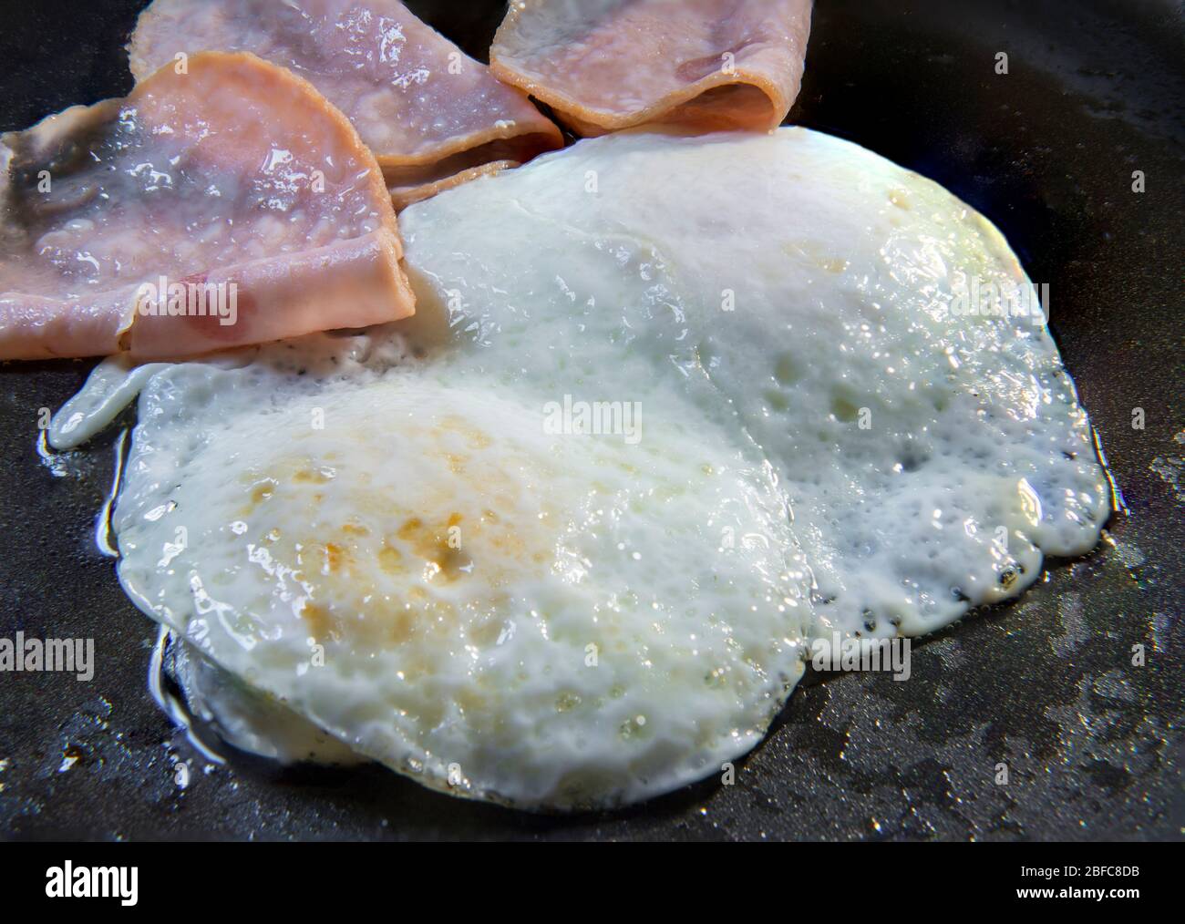 Cooking Fried Over Medium Eggs And Slices Of Ham On An Oily Skillet Classical Breakfast Concept Stock Photo Alamy Cooking Fried Over Medium Eggs And Slices Of Ham On An Oily Skillet Classical Breakfast Concept Stock Photo Alamy