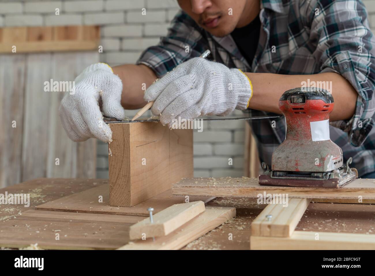Carpenter working on wood craft at to produce construction material or wooden furniture
