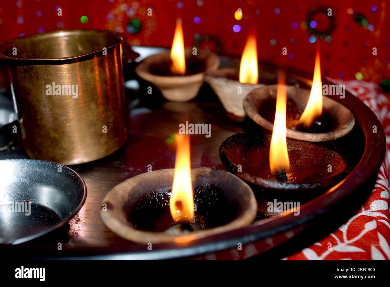Traditional vintage clay oil lamp burning fire, festival lamp of blessing background in India