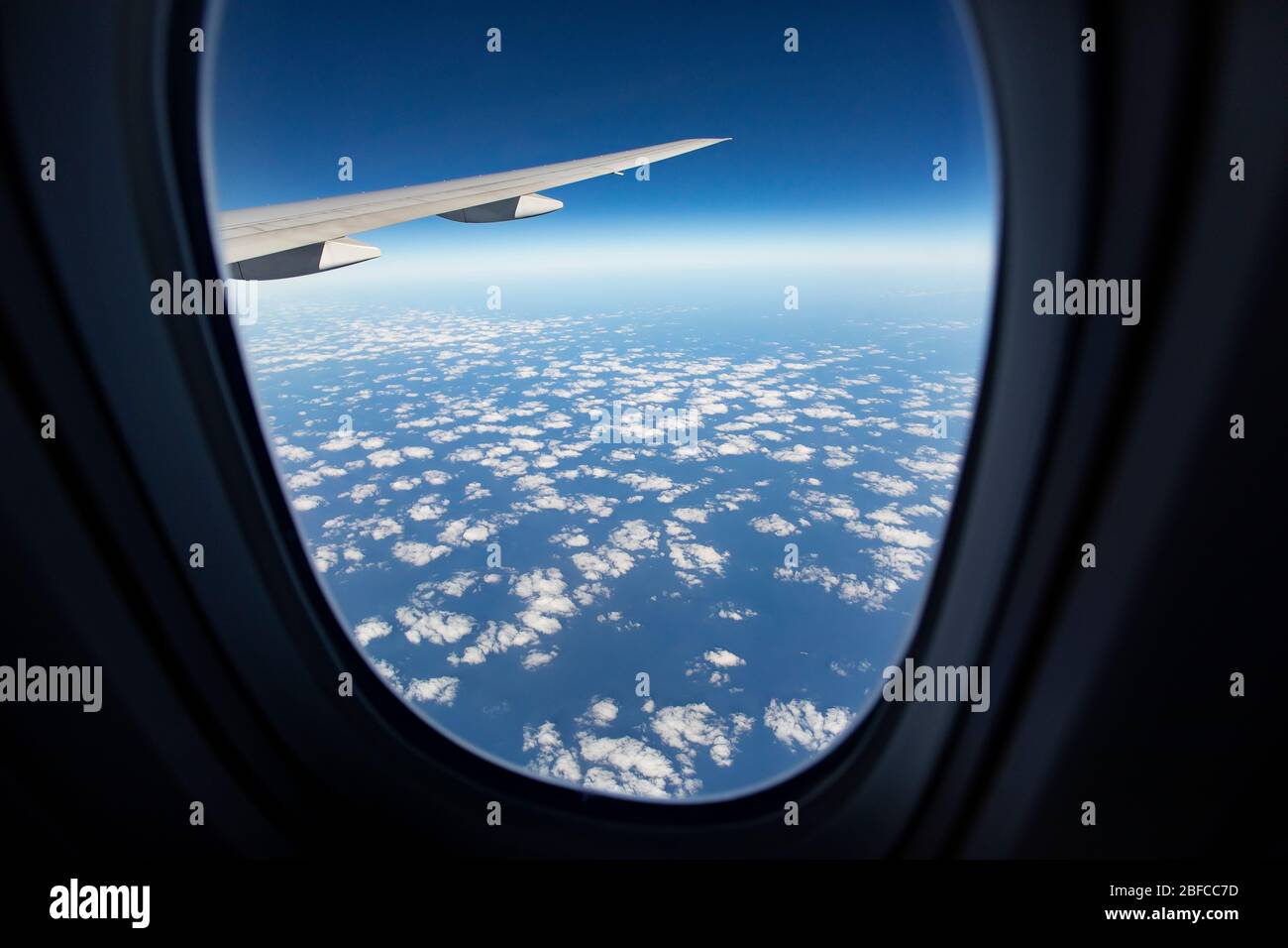 cloudscape against blue sky through air plane window Stock Photo - Alamy