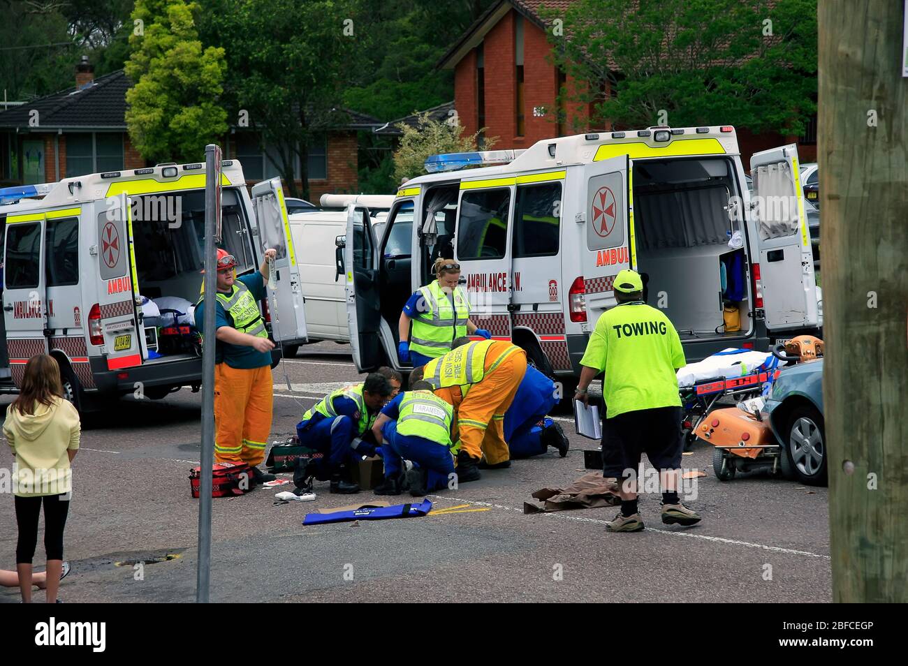 Ambulance and emergency services work on a road accident victim Stock Photo