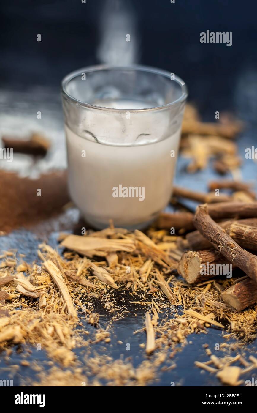 Licorice ayurvedic herb face mask for dark spots on a black wooden board consisting of some