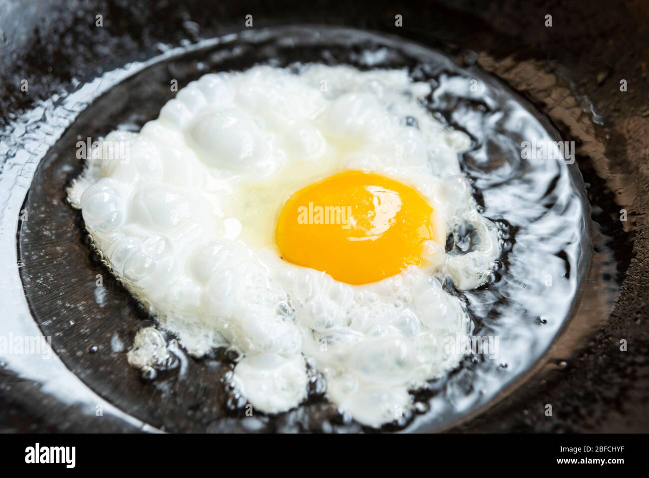fried eggs in a frying pan Stock Photo