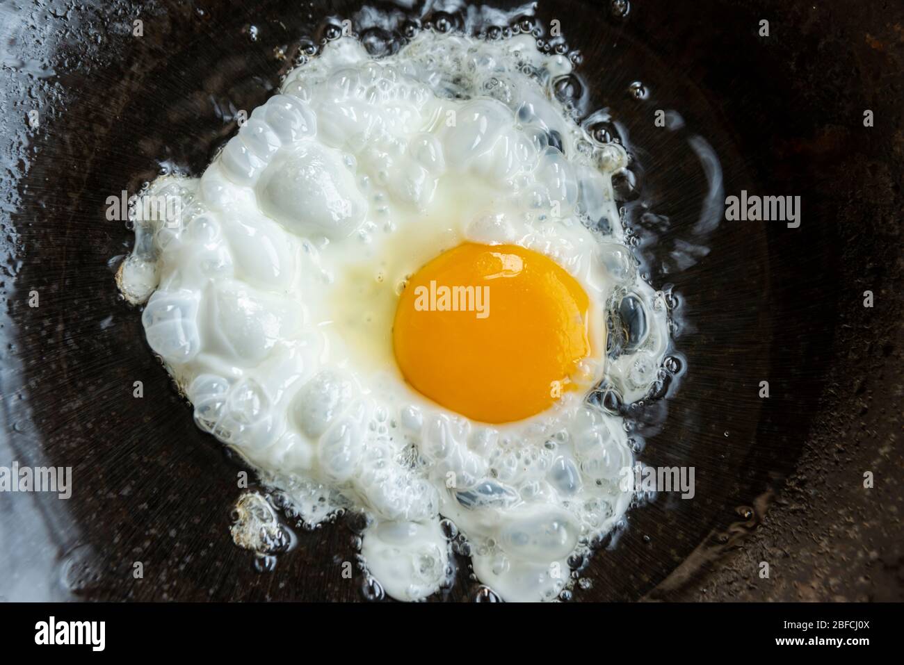 fried eggs in a frying pan Stock Photo - Alamy