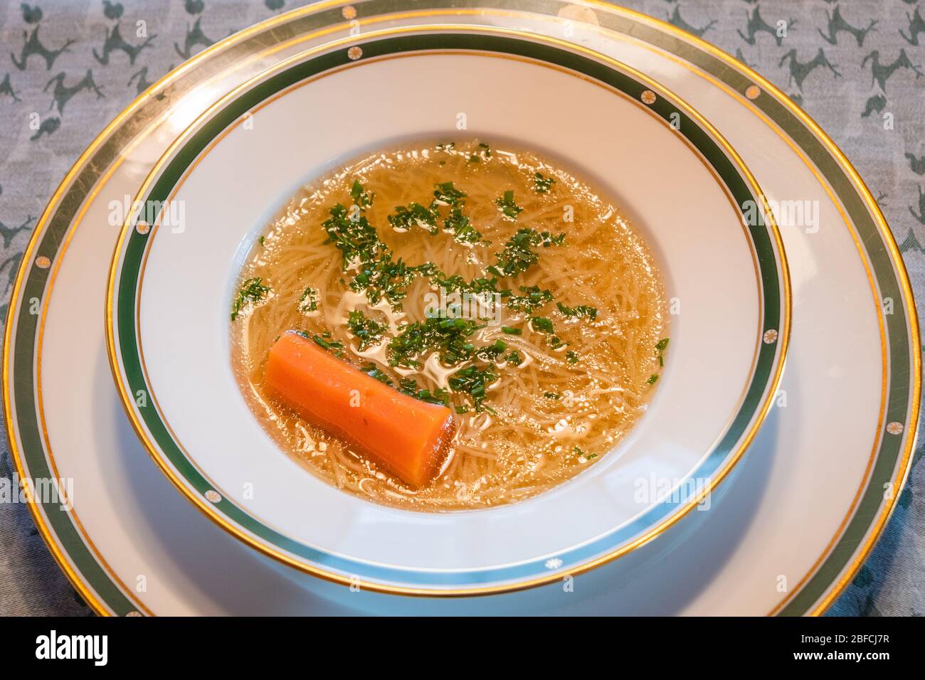 Traditional Viennese Noodle Soup Beef Broth with a Carrot and Chives, a
