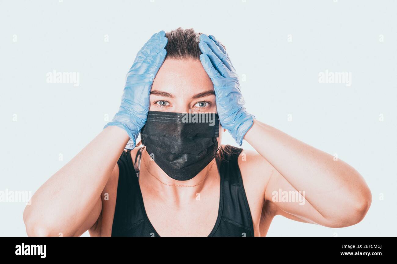 studio shot on white background of a sick young woman wearing mask and ...