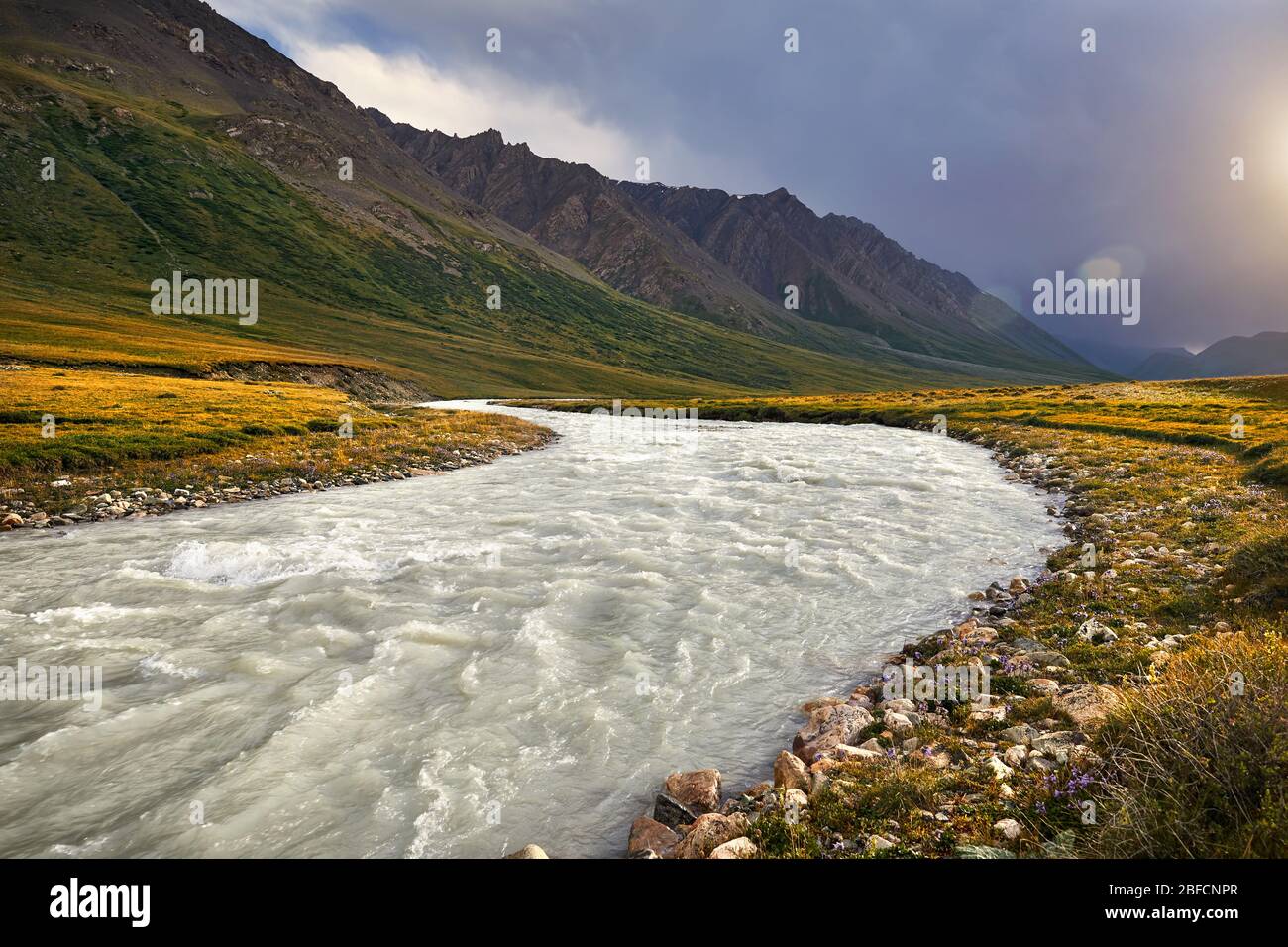 White water river in the mountain valley at sunrise cloudy sky in Kyrgyzstan Stock Photo