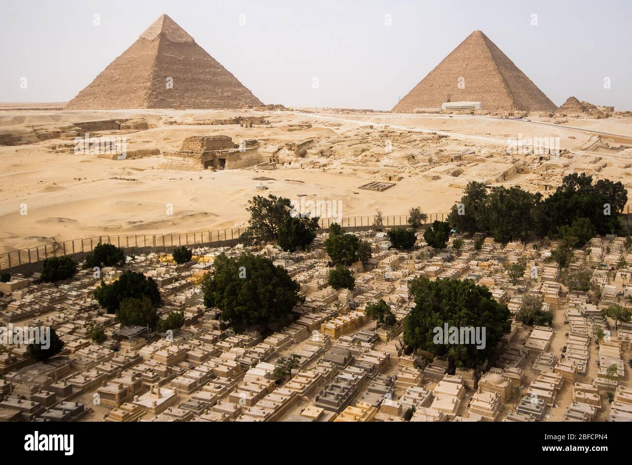 Modern local cemetery in from of the Great Pyramids at Giza, Egypt. Stock Photo