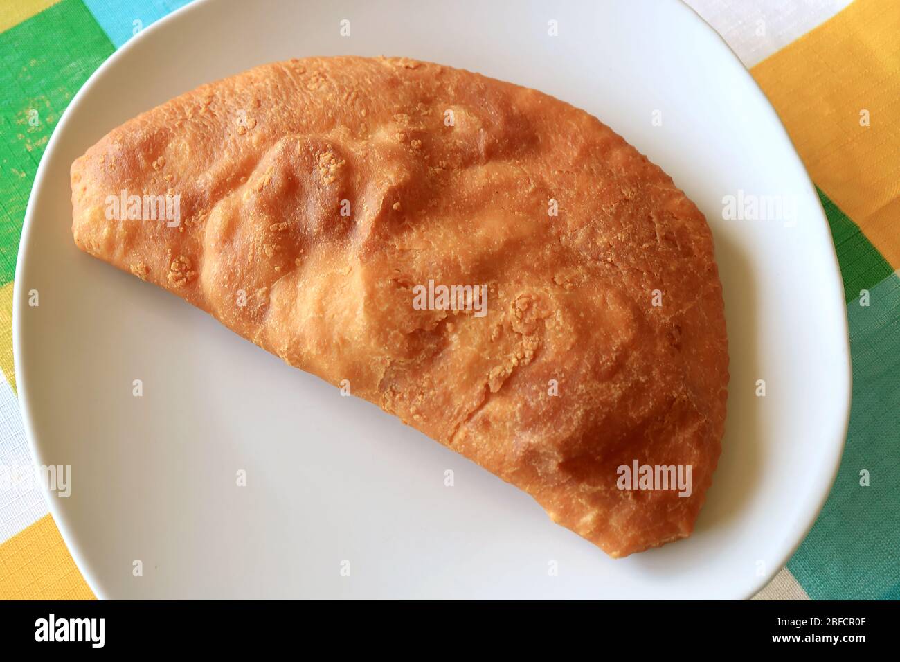Top View of Empanadas, Latin American Famous Stuffed Pastry on White Plate Stock Photo