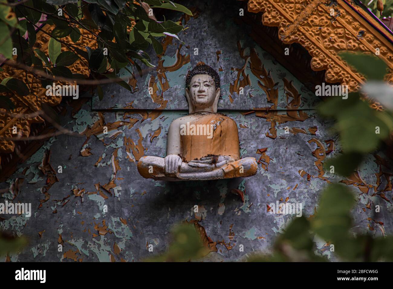 Cinematic photo of an old buddha sculpture in khmer style on an abandoned temple in Bokor Mountains in Kampot Province, Cambodia Stock Photo