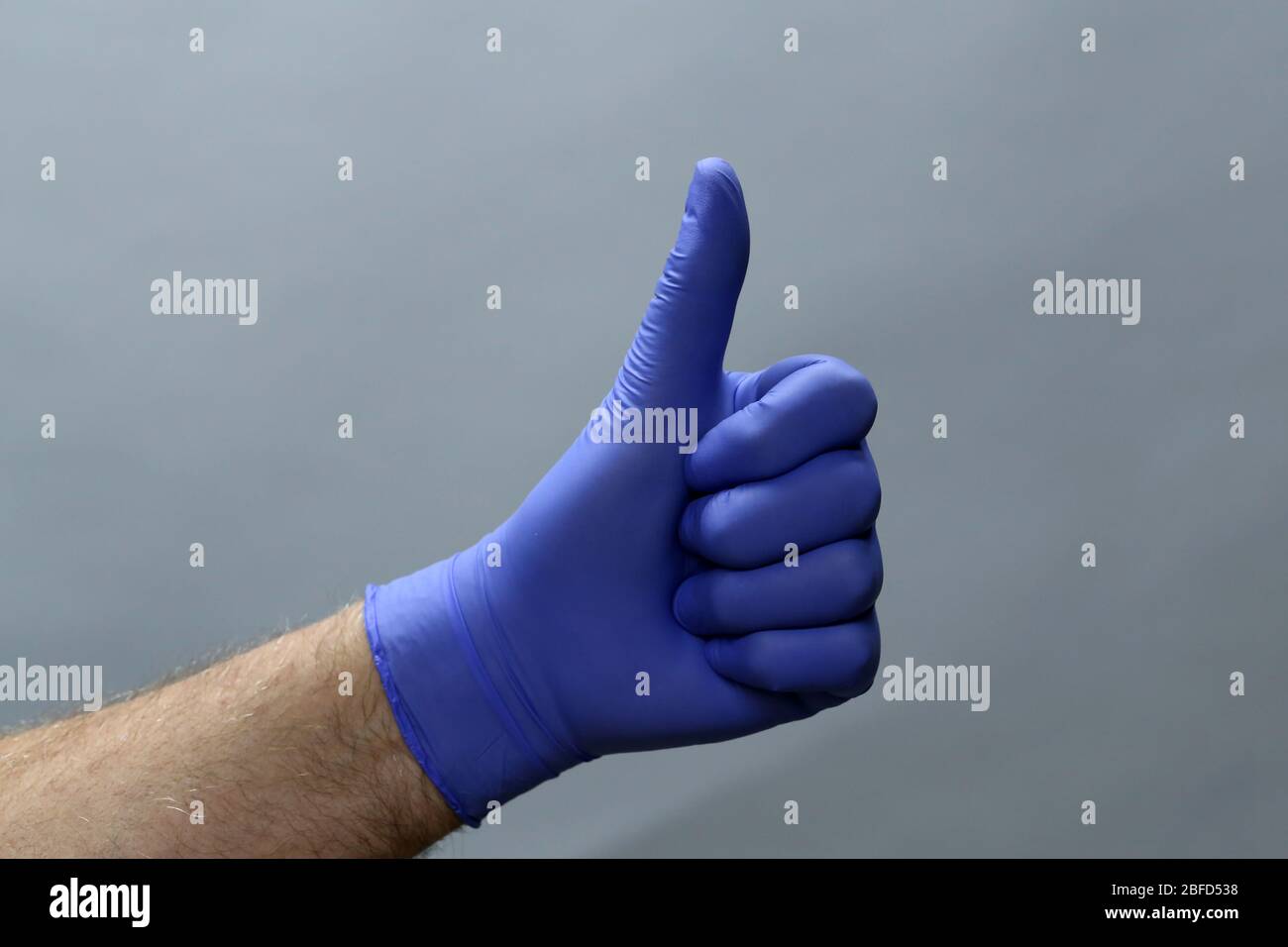 Hand in glove thumbs up hi-res stock photography and images - Alamy