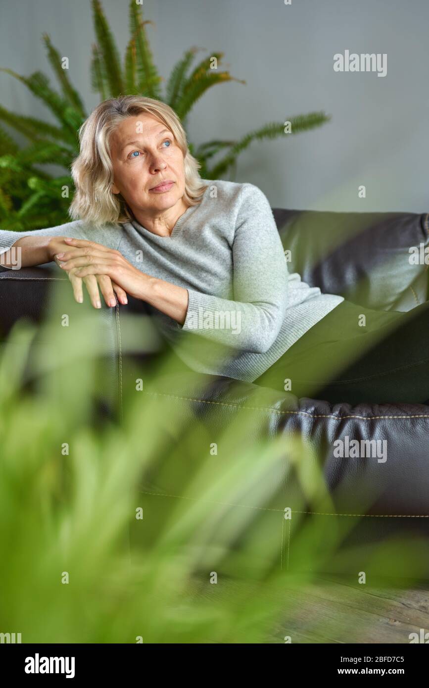 Mature woman lying on couch hi-res stock photography and images - Alamy