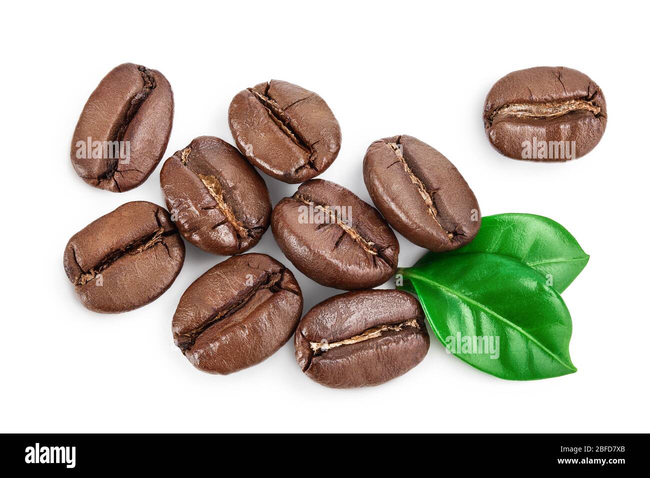 Heap of roasted coffee beans with leaves isolated on white background ...