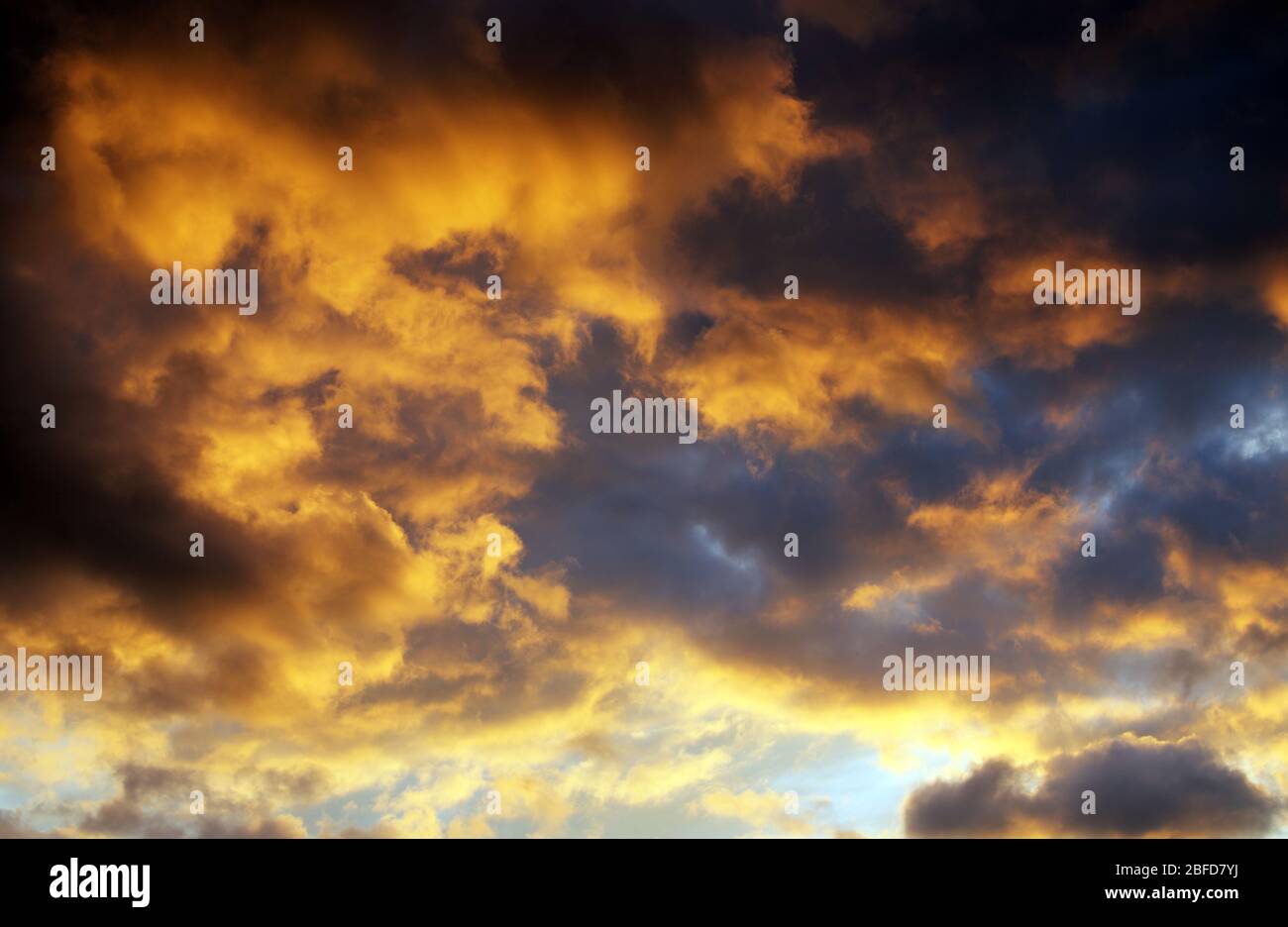 Dramatic orange clouds at sunset background Stock Photo