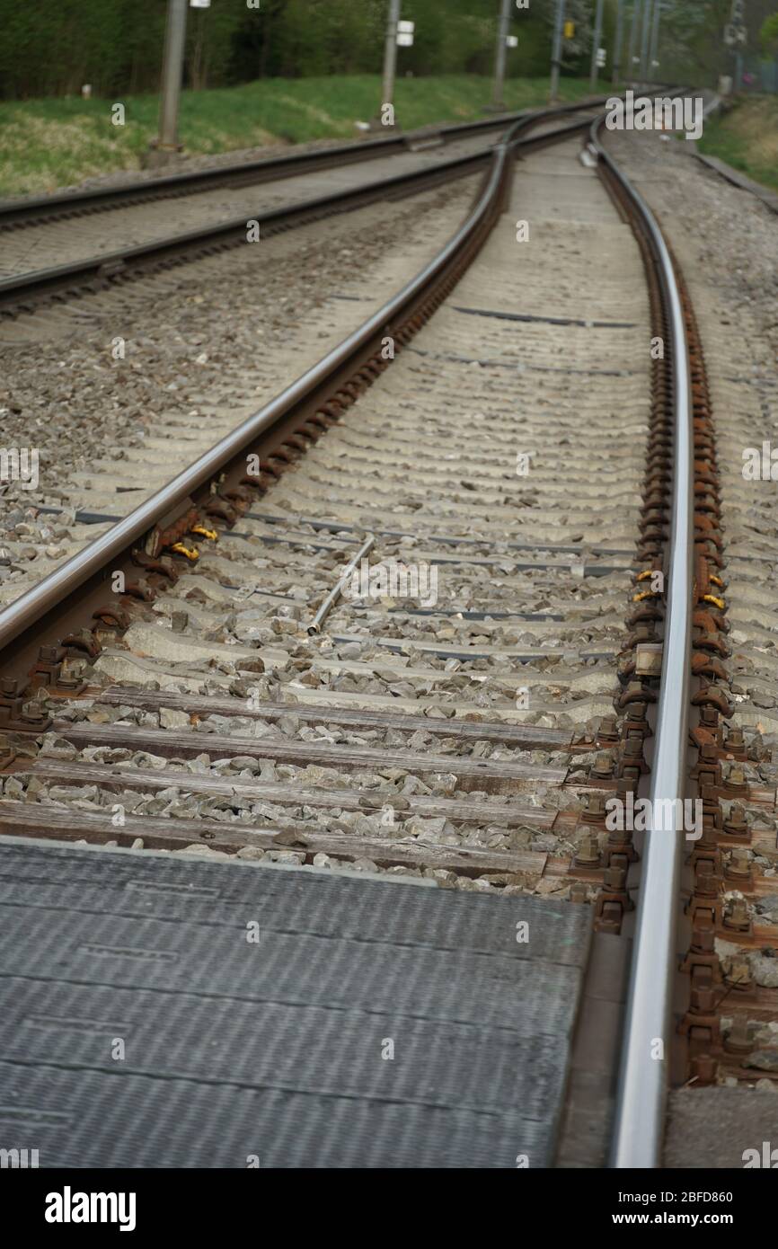 two lanes or tracks of rails meeting in perspective into one, fusion of two  rail lanes or tracks, the photo can have a symbolic meaning Stock Photo -  Alamy