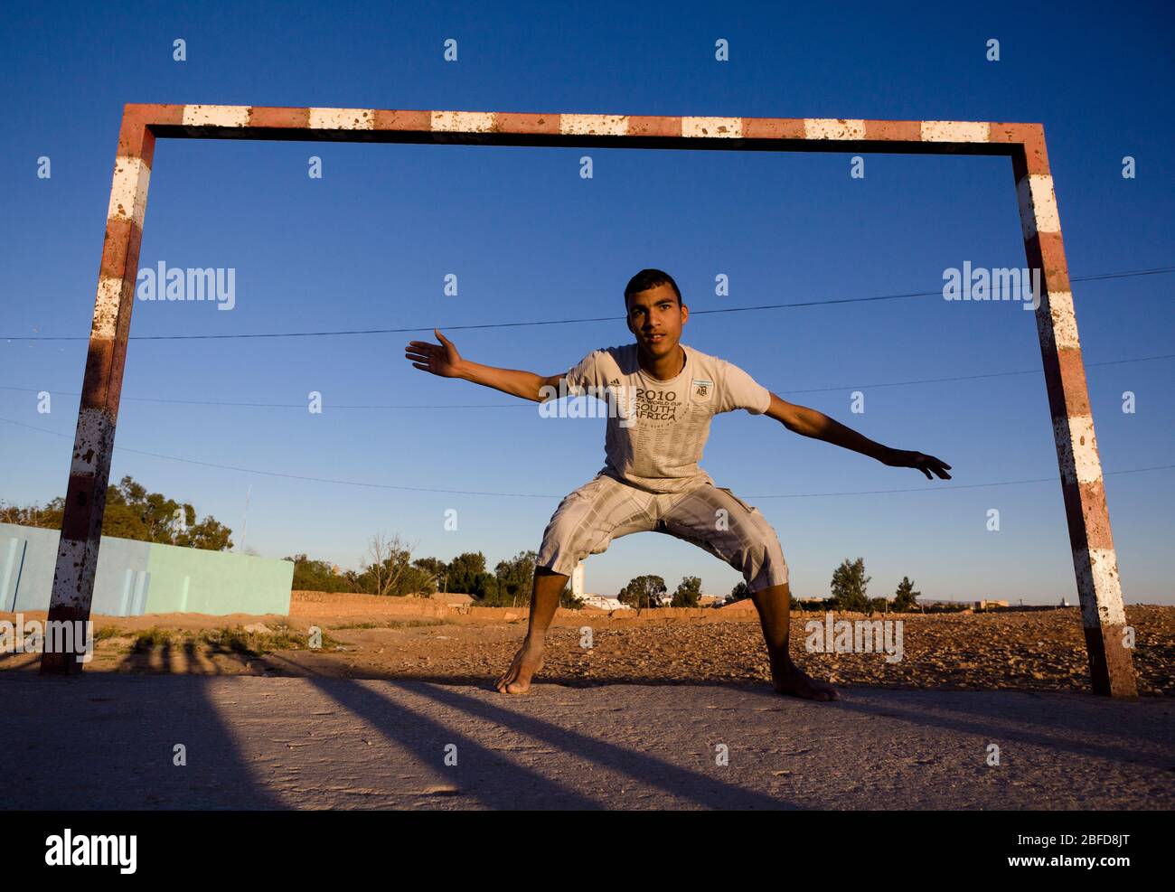 Moroccan boy playing goalkeeper in the Western Sahara, Morocco. Stock Photo