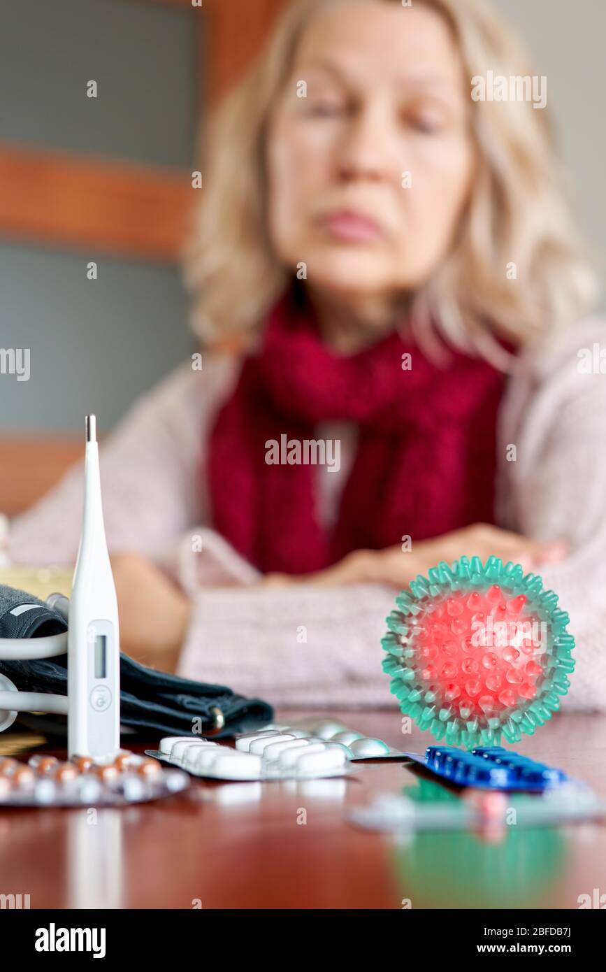 Sickness, seasonal virus problem concept. Senior woman being sick having flu at temperature