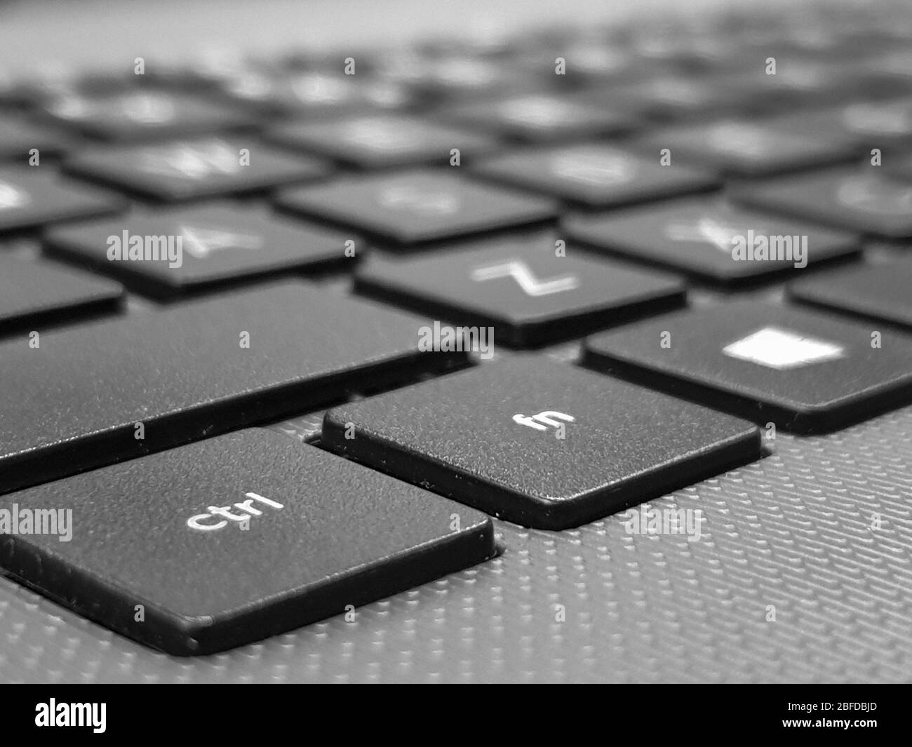 A close up view of a computer keyboard, focussed on the ctrl key, with the shallow depth of field fading into the background. Stock Photo