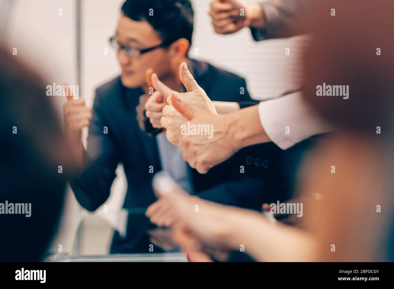 close up. group of young business people showing thumbs up Stock Photo ...